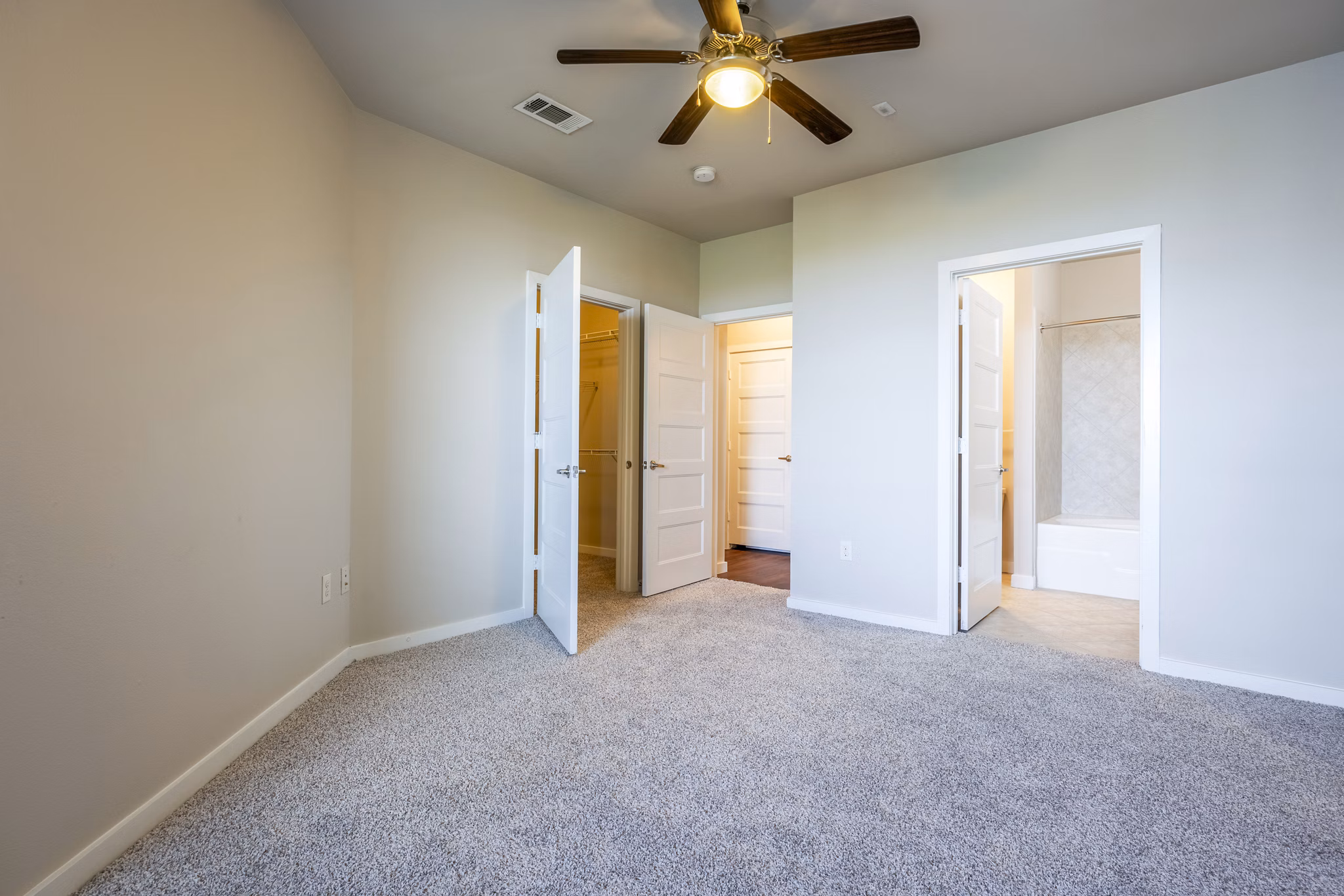 Spacious bedroom with modern decor at Tree Apartments, featuring elegant furnishings and ample natural light
