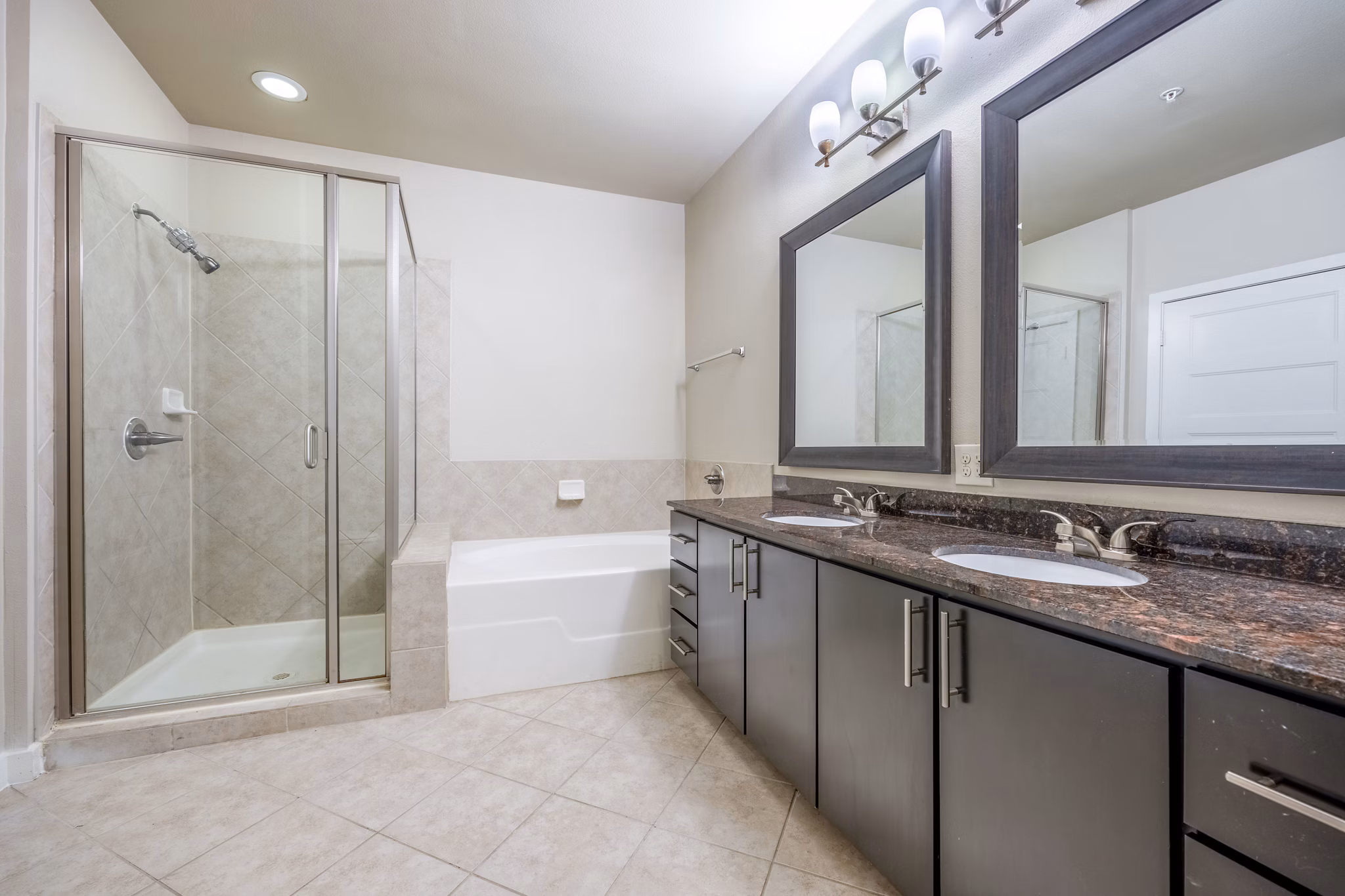 Bathroom with modern fixtures and granite countertops in Tree Apartments