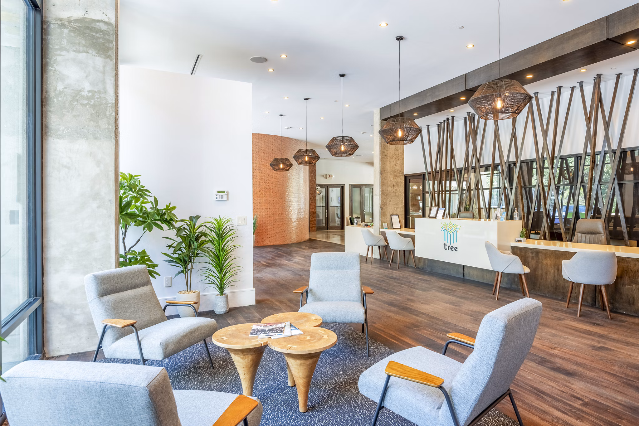 Modern clubhouse with entertainment area at Tree Apartments, a Greystar luxury property