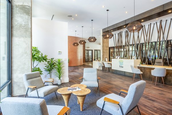 Modern clubhouse with entertainment area at Tree Apartments, a Greystar luxury property