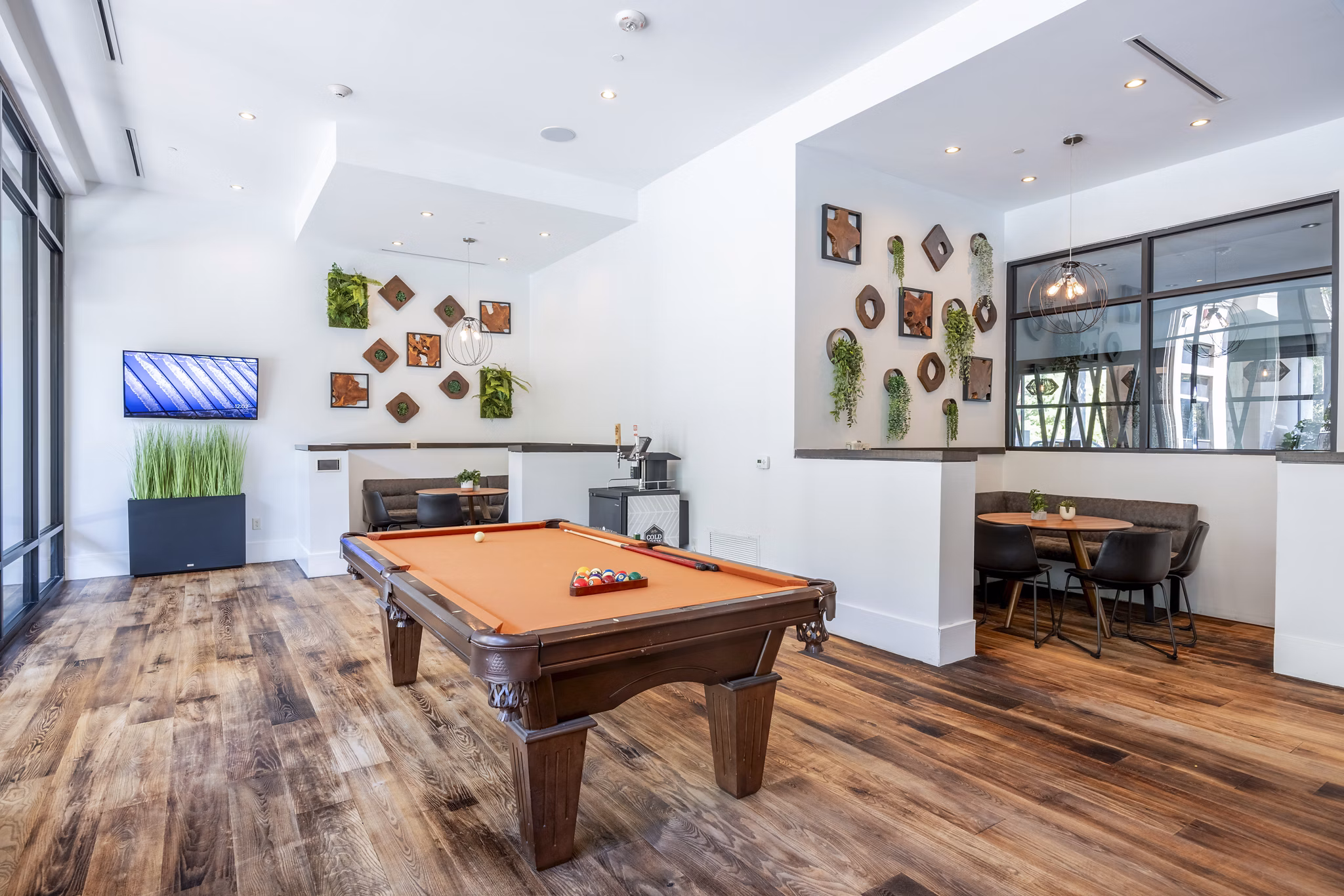 Clubhouse game room featuring pool table and lounge seating at Tree Apartments in luxury Greystar community