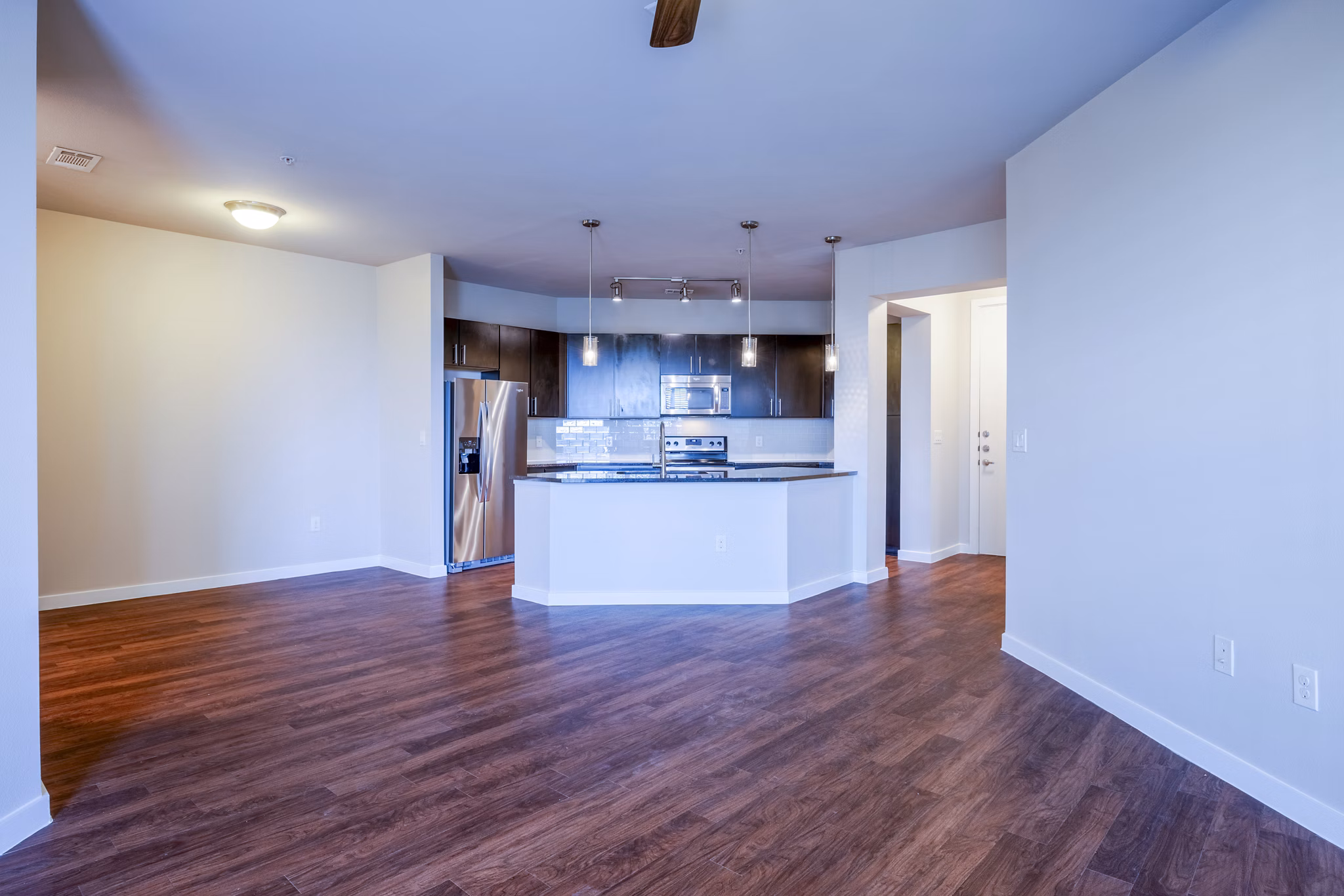 Modern living room featuring sleek furniture and large windows at Tree Apartments, luxury abode by Greystar