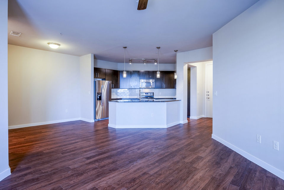 Modern living room featuring sleek furniture and large windows at Tree Apartments, luxury abode by Greystar