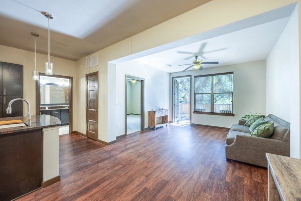 Welcoming living room with cozy seating and artful decor at Tree Apartments, showcasing luxury city living