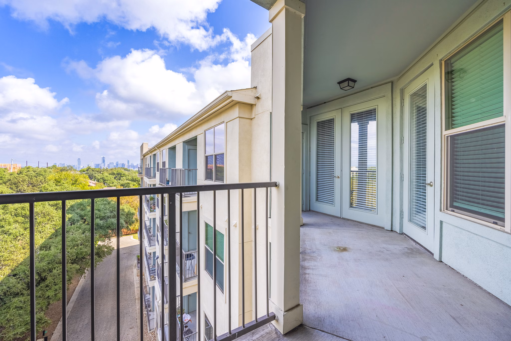 Private patio with modern outdoor furniture at Tree Apartments, offering relaxing views for residents