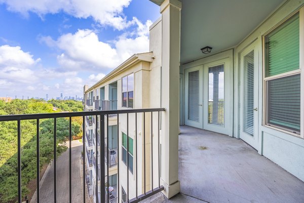 Private patio with modern outdoor furniture at Tree Apartments, offering relaxing views for residents
