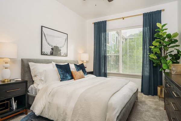 Modern bedroom with large windows at Lakeshore Pearl Apartments offering luxurious living in a prime location