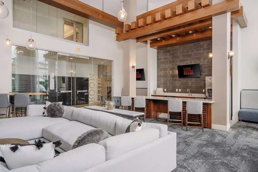Clubhouse featuring modern design and ample seating at Lakeshore Pearl Apartments in a vibrant community setting