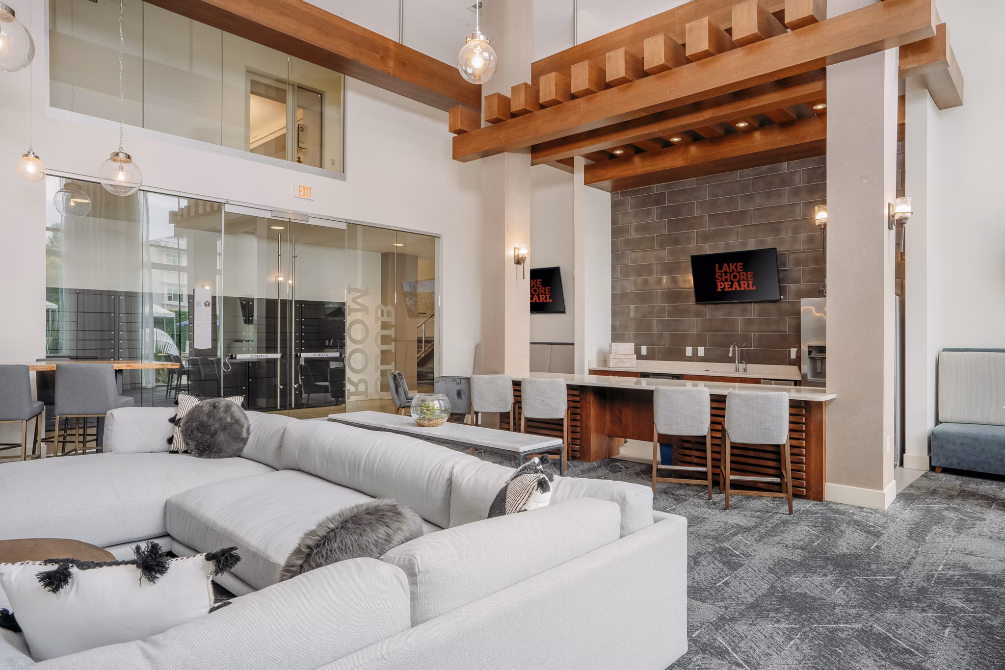 Clubhouse featuring modern design and ample seating at Lakeshore Pearl Apartments in a vibrant community setting