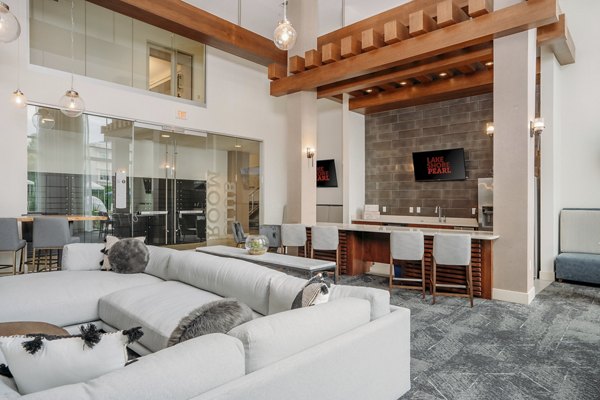 Clubhouse featuring modern design and ample seating at Lakeshore Pearl Apartments in a vibrant community setting