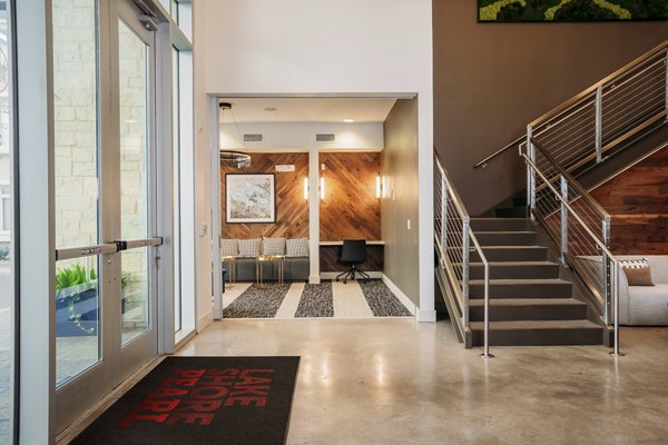 Clubhouse with modern design and ample seating at Lakeshore Pearl Apartments, offering luxury amenities and vibrant community spaces