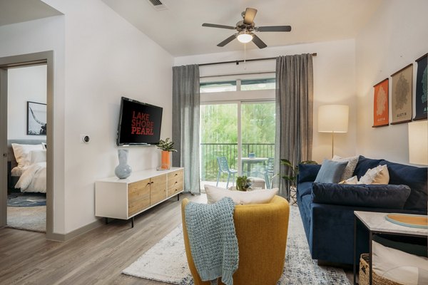Modern living room with stylish decor and ample natural light at Lakeshore Pearl Apartments