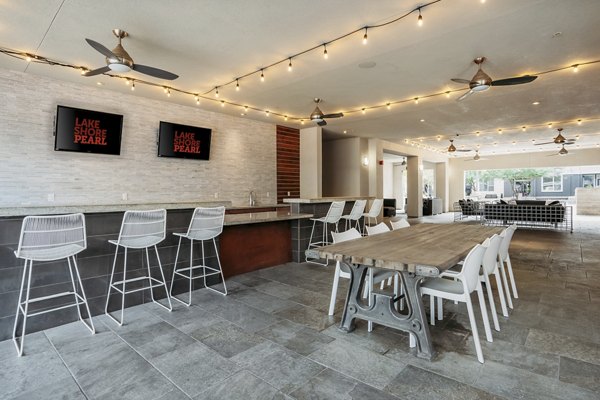Modern patio with seating area at Lakeshore Pearl Apartments overlooking serene views