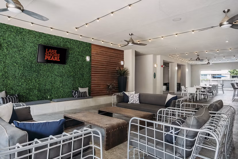 Lakeshore Pearl Apartments: Cozy patio with comfortable seating and lush greenery for leisure in a luxury apartment setting