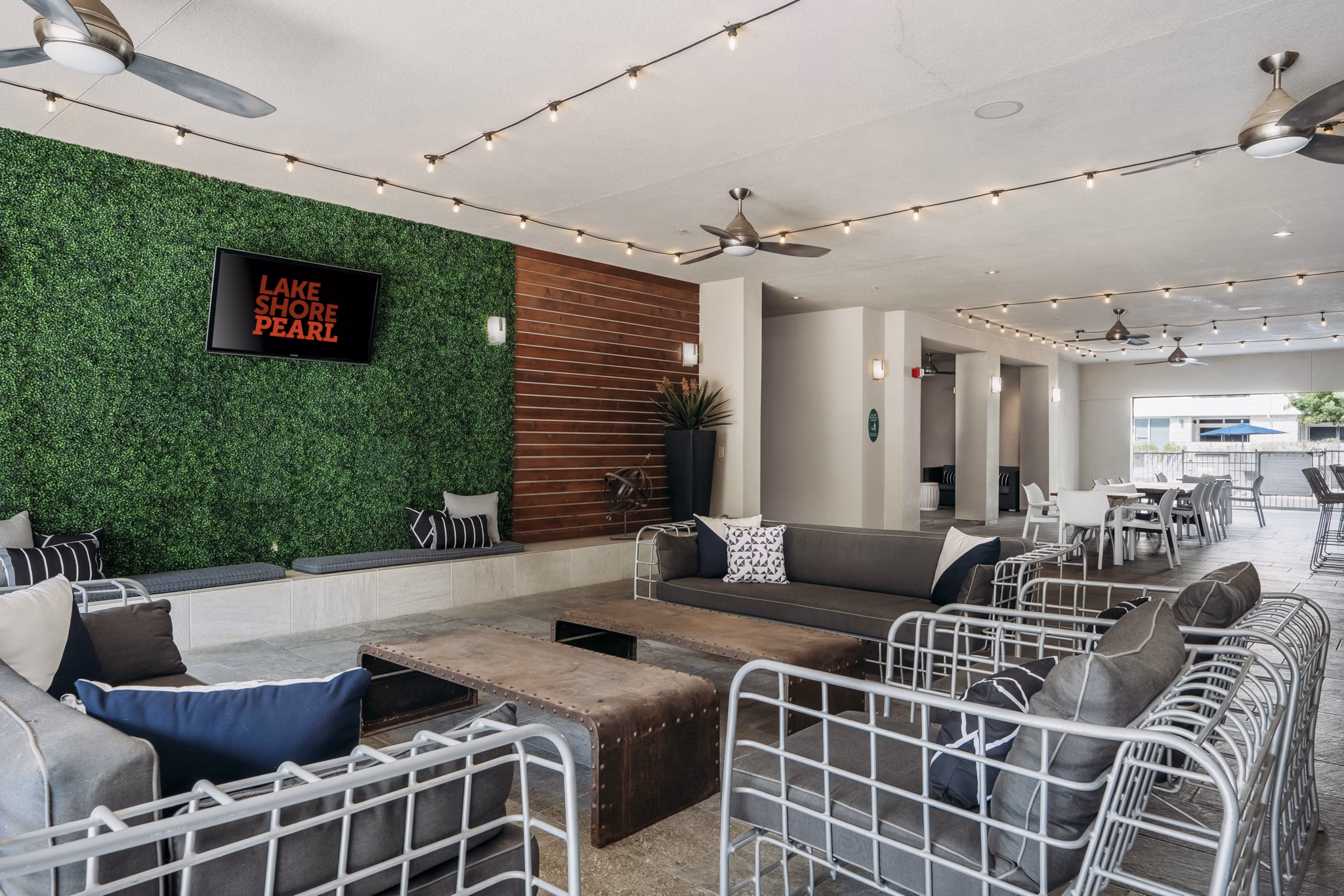 Lakeshore Pearl Apartments: Cozy patio with comfortable seating and lush greenery for leisure in a luxury apartment setting
