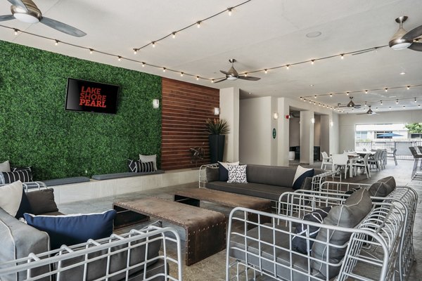 Lakeshore Pearl Apartments: Cozy patio with comfortable seating and lush greenery for leisure in a luxury apartment setting