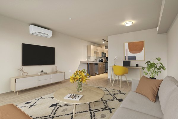 Modern living room with plush seating and stylish decor at 708 Uptown Apartments, offering luxurious urban living experiences