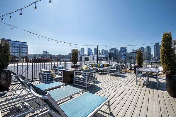 Patio with cozy seating and outdoor fireplace at 708 Uptown Apartments