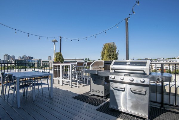 Stylish outdoor patio at 708 Uptown Apartments featuring modern furniture and lush greenery