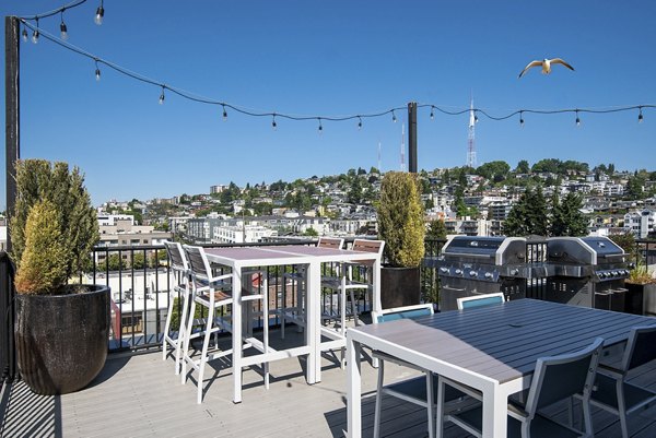 French doors open to a stylish patio with cozy seating at 708 Uptown Apartments