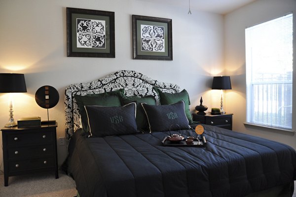Modern bedroom with elegant decor at Avanti Cityside Apartments, featuring plush bedding and ample natural light