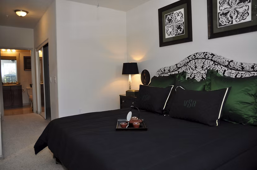 Modern bedroom featuring chic decor and large windows at Avanti Cityside Apartments