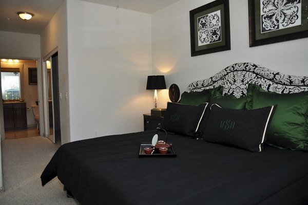 Modern bedroom featuring chic decor and large windows at Avanti Cityside Apartments
