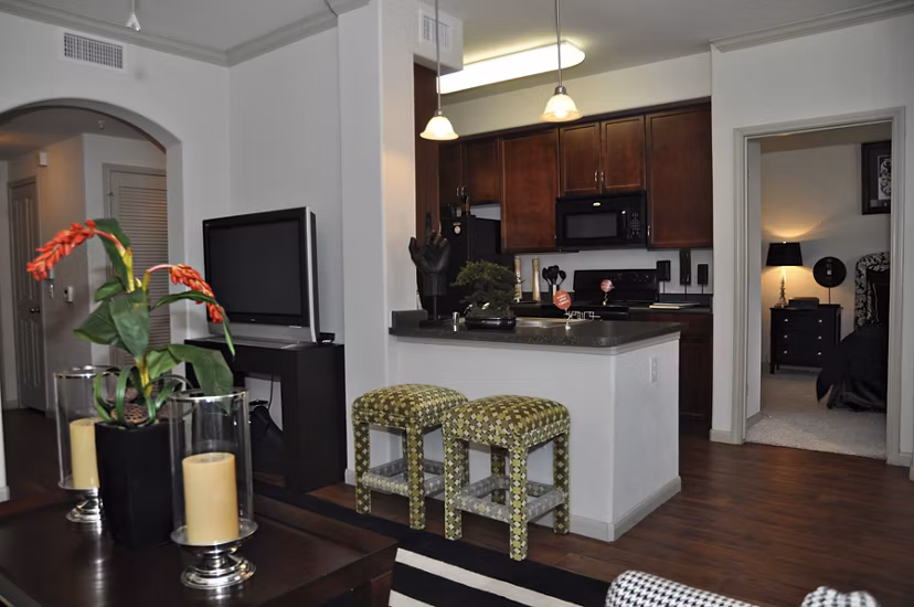 Modern kitchen with stainless steel appliances and granite countertops in Avanti Cityside Apartments
