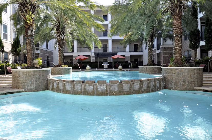 Resort-style pool at Avanti Cityside Apartments featuring lush landscaping and sundeck