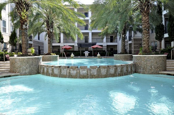 Resort-style pool at Avanti Cityside Apartments featuring lush landscaping and sundeck