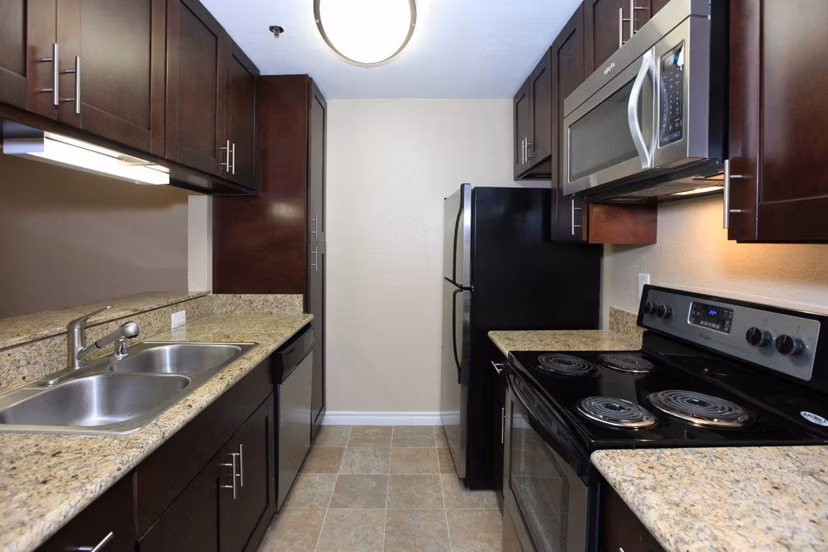 Modern kitchen with sleek appliances at City View Apartments