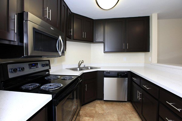 Modern kitchen with stainless steel appliances at City View Apartments, featuring sleek countertops and ample cabinet space