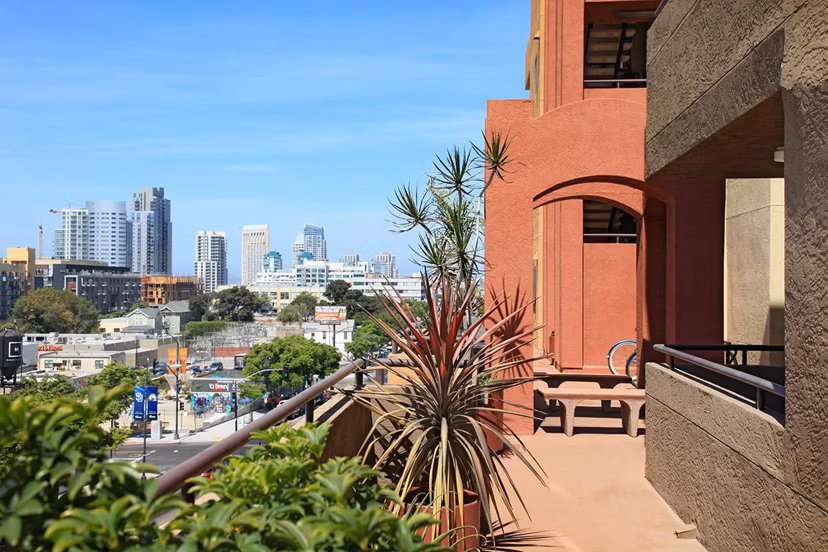 Spacious patio with modern outdoor seating at City View Apartments, offering stunning city views for relaxation and socializing
