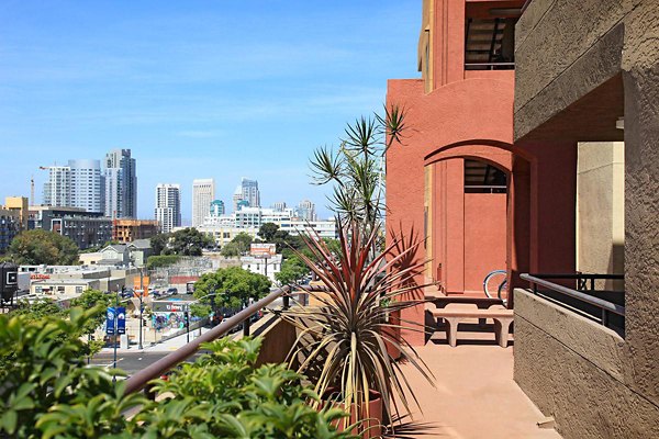 Spacious patio with modern outdoor seating at City View Apartments, offering stunning city views for relaxation and socializing