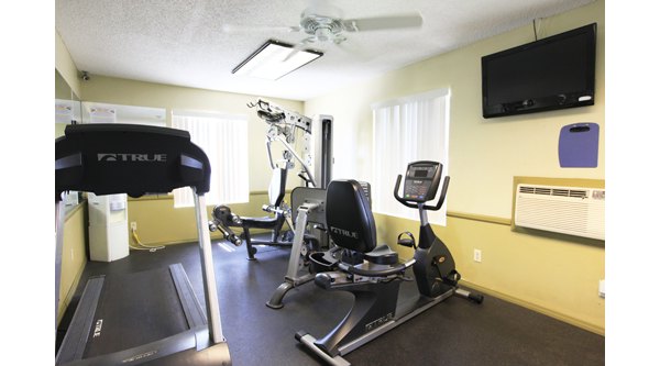Modern fitness center with state-of-the-art equipment at Ocean Breeze Apartments Ideal for wellness-focused residents in a luxurious setting
