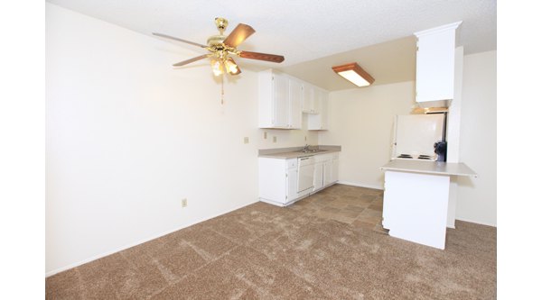 Modern kitchen with stainless steel appliances and island at Ocean Breeze Apartments