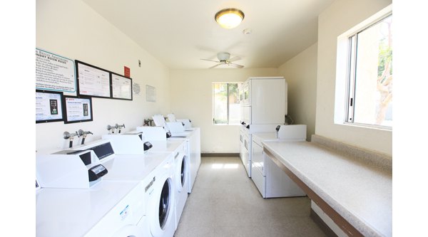 Modern laundry facility at Ocean Breeze Apartments featuring energy-efficient machines for resident convenience