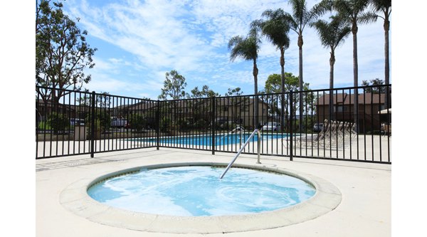 Relaxing outdoor hot tub at Ocean Breeze Apartments offering scenic views