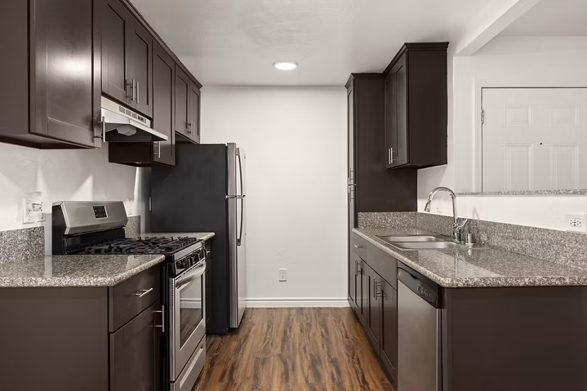 Modern kitchen with stainless appliances at Whispering Oaks Apartments, Greystar luxury apartments