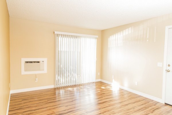 Spacious living room with modern decor in Whispering Oaks Apartments