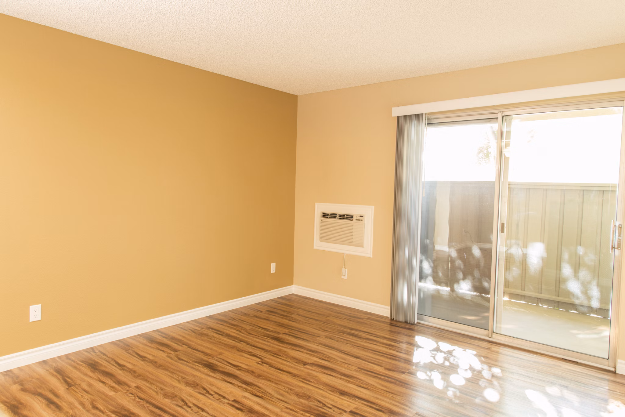 Contemporary living room with stylish decor and expansive windows at Whispering Oaks Apartments
