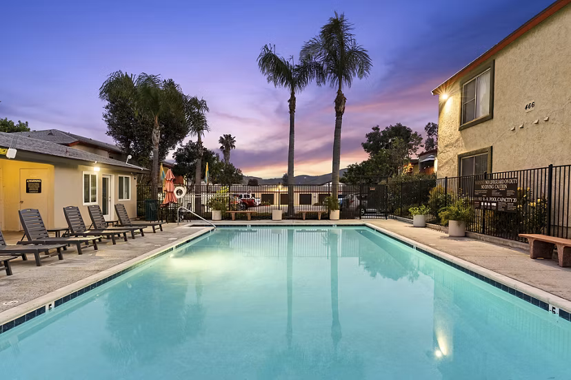 Pool with sun loungers at Whispering Oaks Apartments, a Greystar luxury community