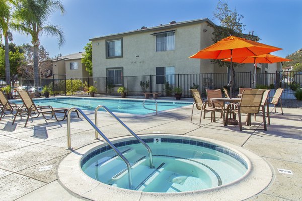 Pool with sun loungers at Whispering Oaks Apartments, a Greystar luxury community