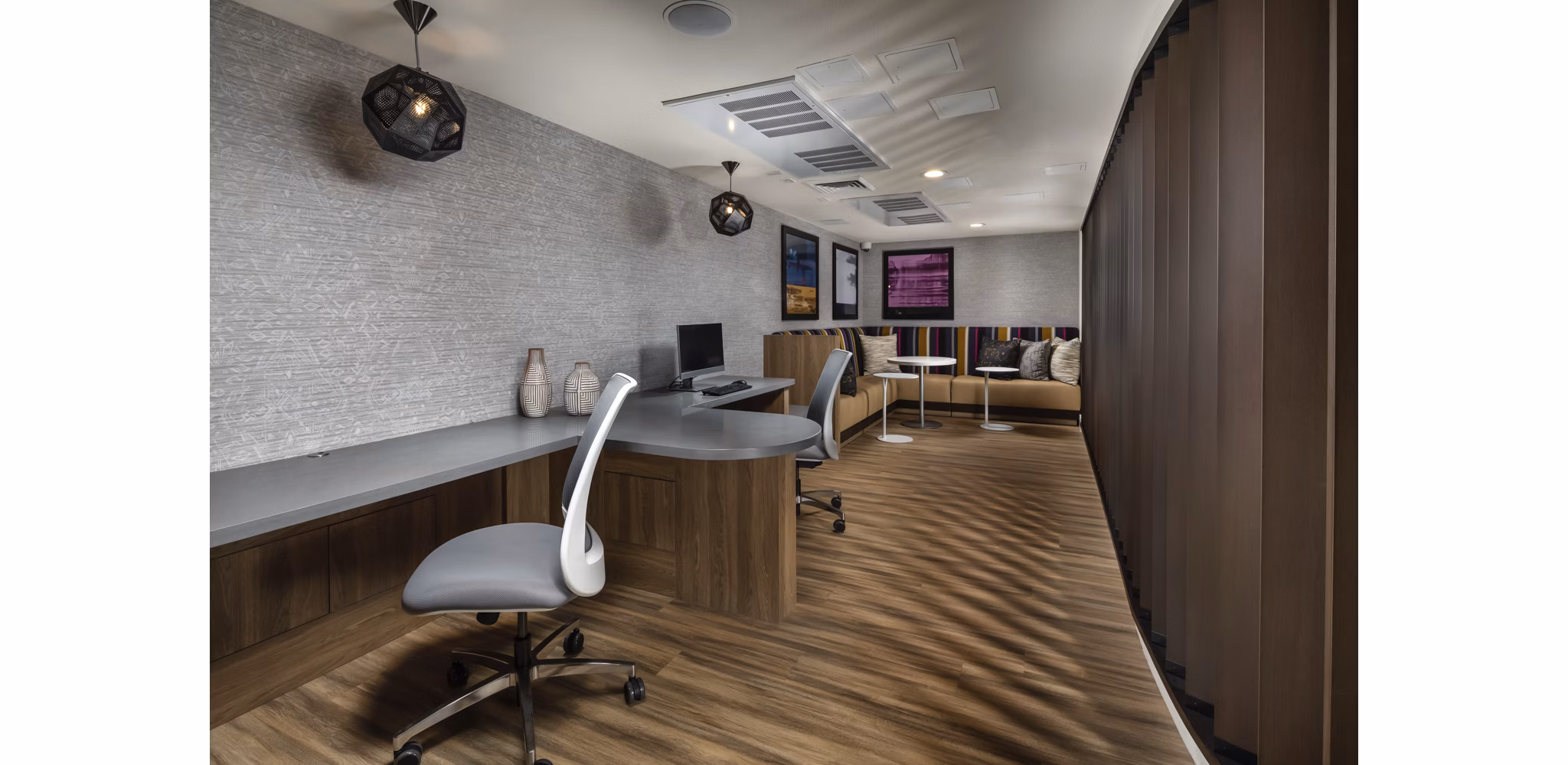 Clubhouse at The Pointe at Warner Center Apartments featuring modern design and spacious seating in a luxury residential community