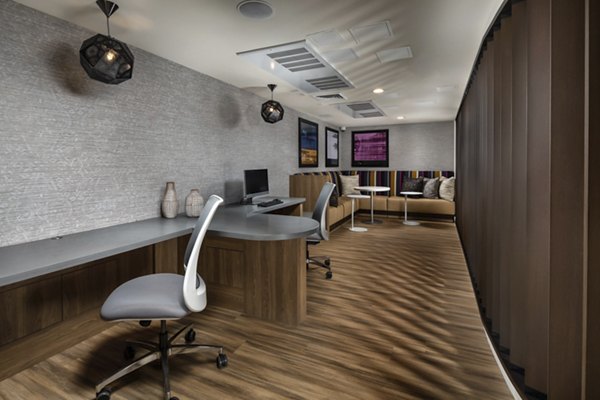 Clubhouse at The Pointe at Warner Center Apartments featuring modern design and spacious seating in a luxury residential community