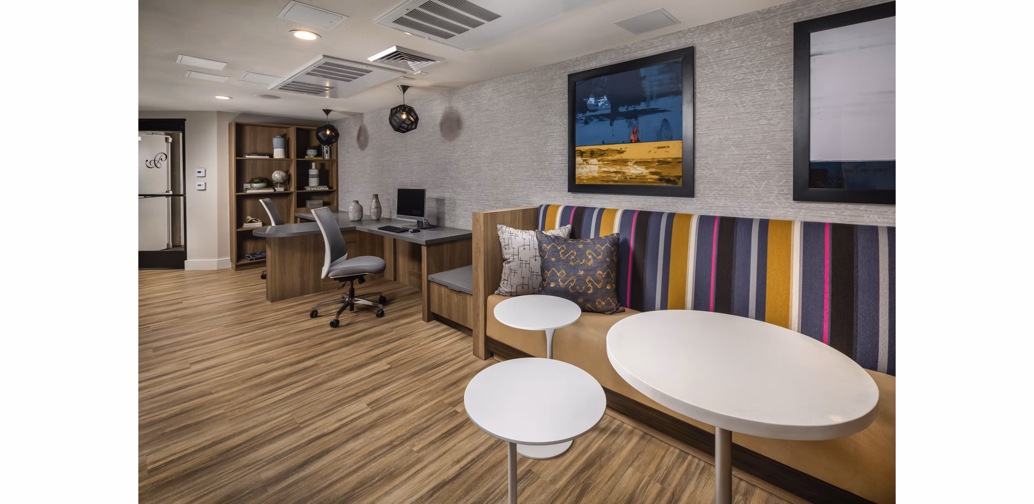 Clubhouse featuring modern design and open seating at The Pointe at Warner Center Apartments