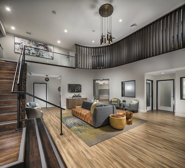 Clubhouse featuring modern design and plush seating at The Pointe at Warner Center Apartments