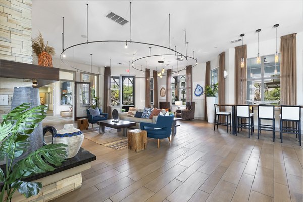 Clubhouse featuring modern design and seating areas at 95Twenty Apartments