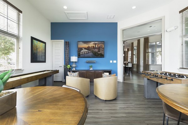 Clubhouse with modern seating and entertainment area at 95Twenty Apartments