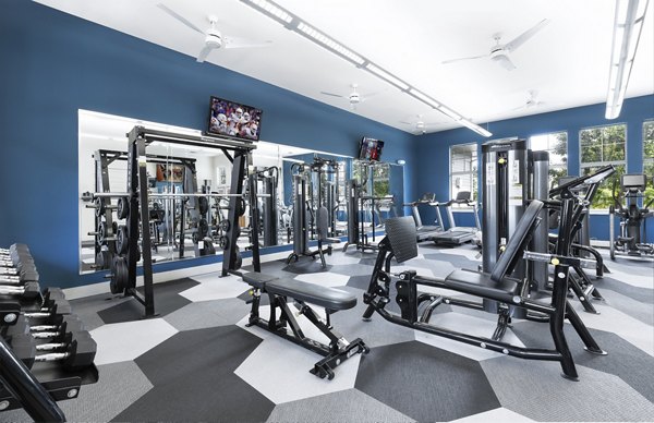 Modern fitness center with state-of-the-art equipment at 95Twenty Apartments, offering residents a high-end workout experience